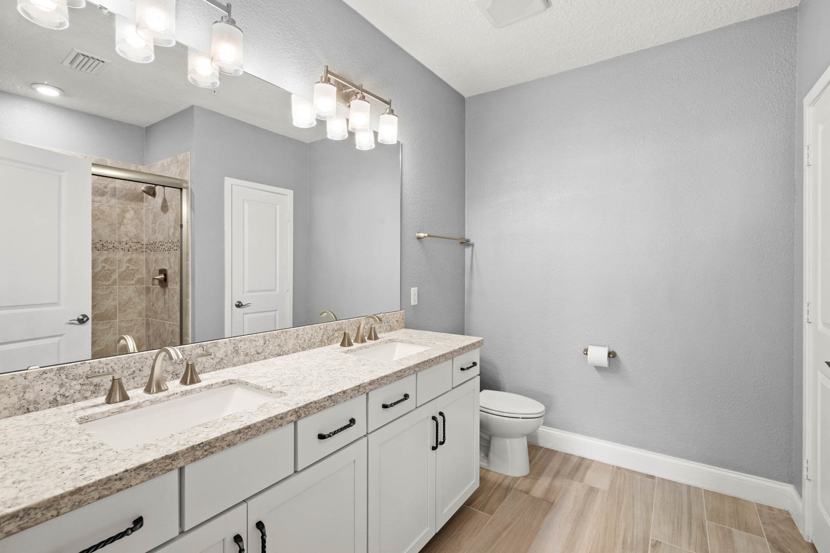 bathroom with marble counters and double sinks